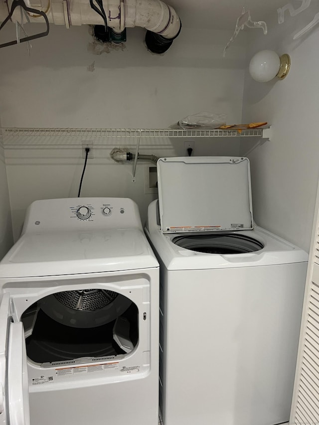 clothes washing area featuring independent washer and dryer