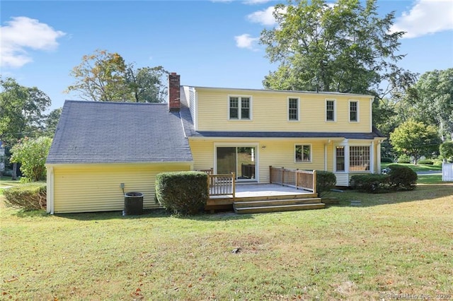 back of house featuring a yard and a wooden deck