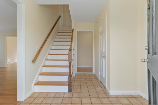 stairway featuring tile patterned flooring