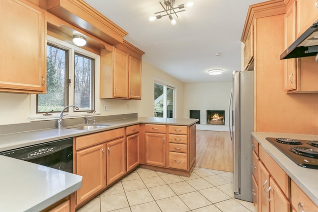 kitchen featuring stainless steel fridge, ventilation hood, sink, electric cooktop, and black dishwasher