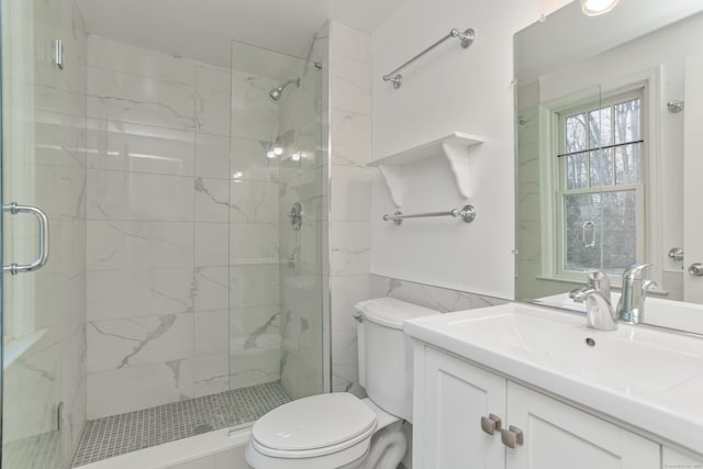 bathroom featuring vanity, toilet, and an enclosed shower