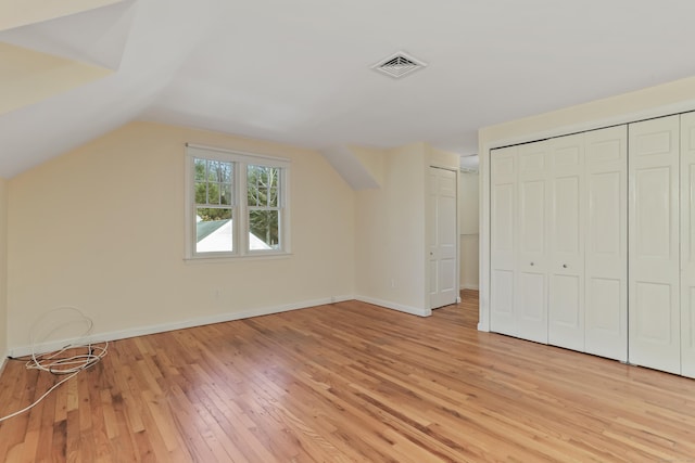 bonus room featuring vaulted ceiling and light hardwood / wood-style flooring