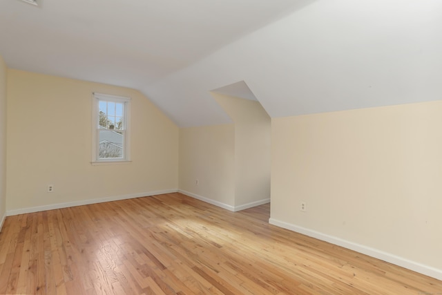 bonus room featuring light hardwood / wood-style floors and vaulted ceiling