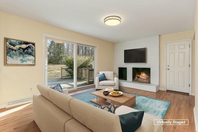 living room with a fireplace and light hardwood / wood-style flooring