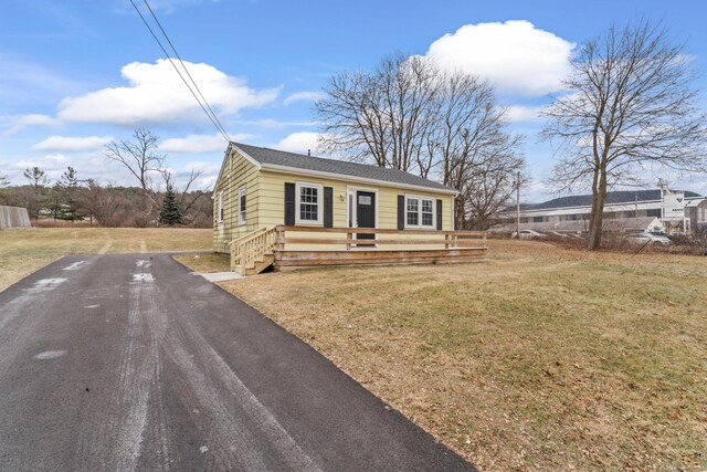 view of front of home featuring a deck and a front lawn