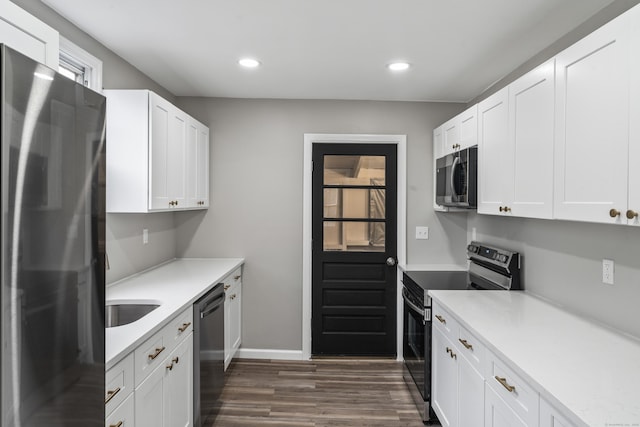 kitchen with dark hardwood / wood-style flooring, white cabinets, and black appliances