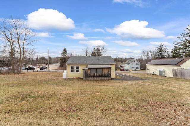 back of property with a lawn