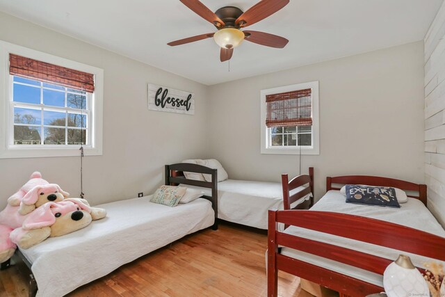 bedroom with ceiling fan and hardwood / wood-style flooring