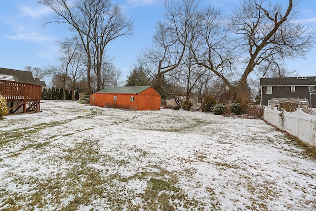 snowy yard featuring an outdoor structure