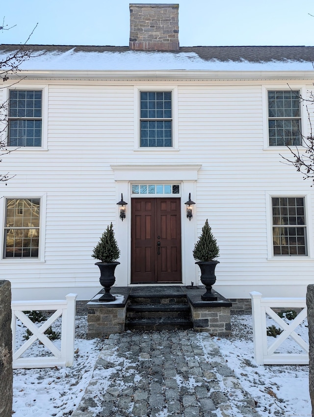 view of snow covered property entrance