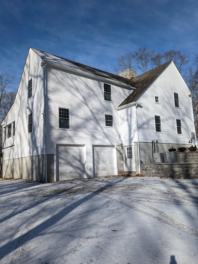 back of house featuring a garage