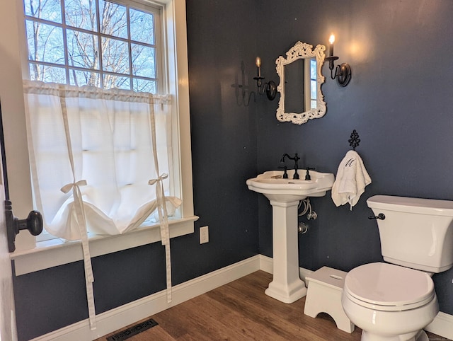 bathroom featuring hardwood / wood-style floors and toilet