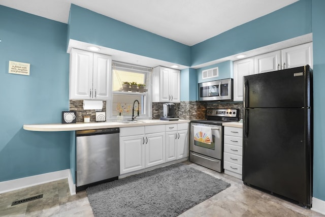 kitchen featuring decorative backsplash, white cabinetry, sink, and appliances with stainless steel finishes