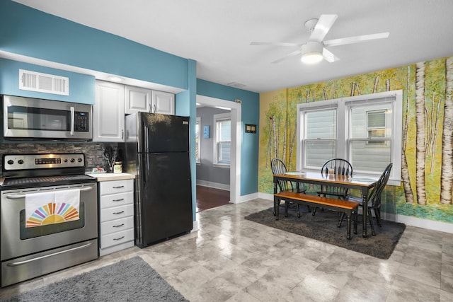 kitchen featuring backsplash, ceiling fan, white cabinetry, and stainless steel appliances