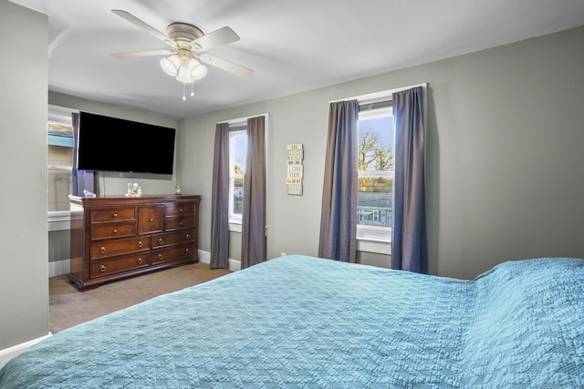 bedroom featuring ceiling fan and light colored carpet