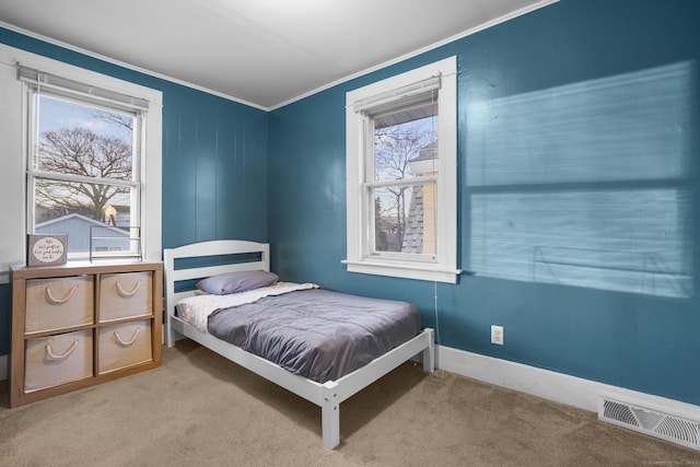 carpeted bedroom with crown molding