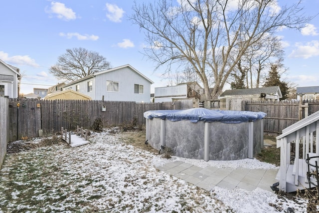 snowy yard featuring a covered pool