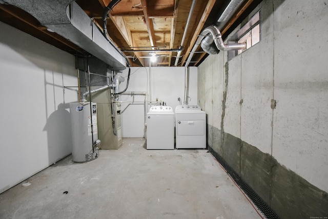 basement featuring washing machine and clothes dryer and water heater