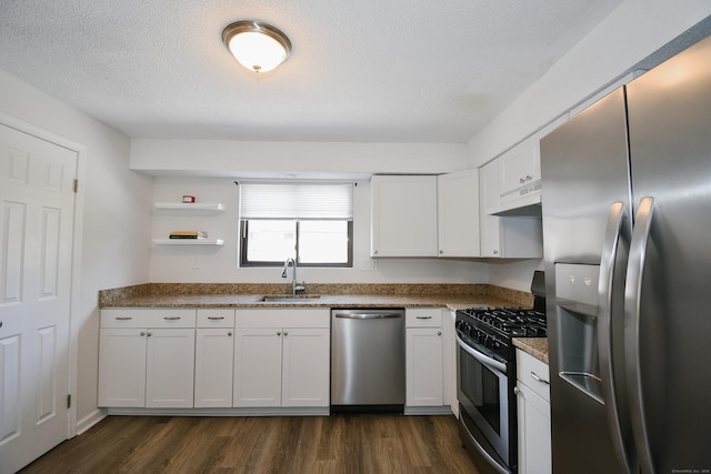 kitchen with dark hardwood / wood-style flooring, a textured ceiling, stainless steel appliances, sink, and white cabinets