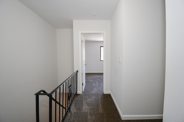 hallway with dark carpet