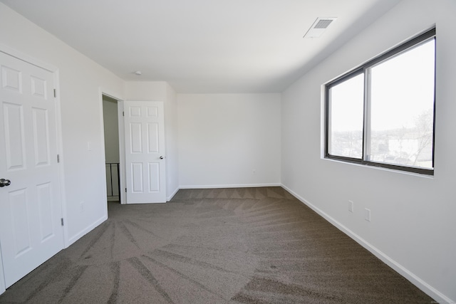 empty room with dark carpet