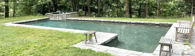 view of dock featuring a swimming pool with hot tub and a lawn