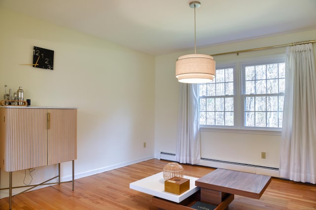 interior space featuring a healthy amount of sunlight, light wood finished floors, and baseboards