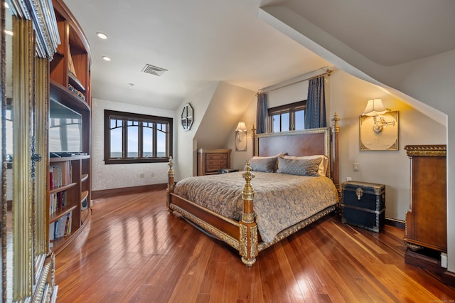 bedroom featuring wood-type flooring, visible vents, and baseboards