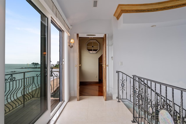 hallway with lofted ceiling, tile patterned flooring, an upstairs landing, and visible vents