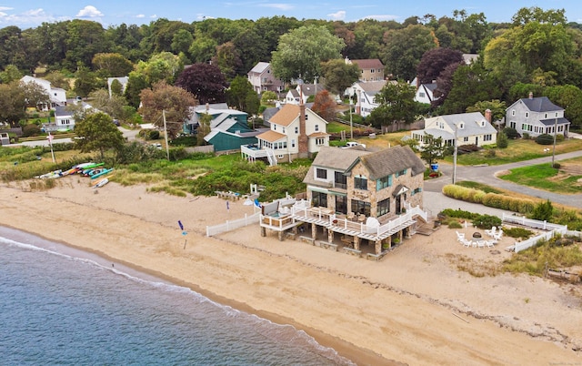 aerial view with a water view, a residential view, and a beach view