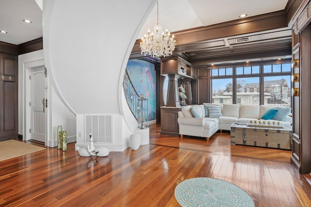 interior space featuring visible vents, baseboards, stairs, wood-type flooring, and an inviting chandelier