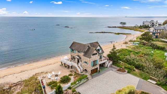 drone / aerial view featuring a water view and a view of the beach