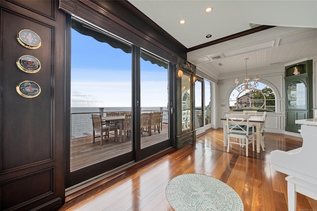 sunroom / solarium with a chandelier