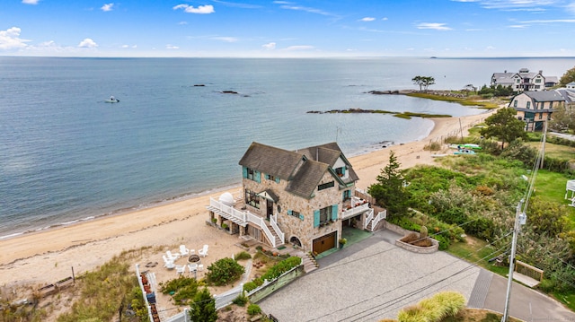 birds eye view of property featuring a water view and a beach view