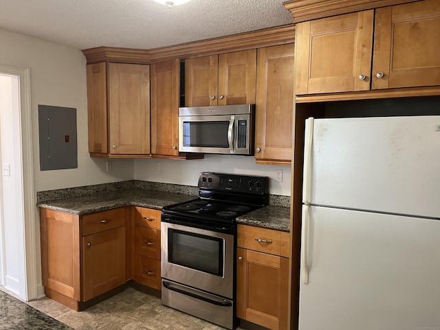 kitchen featuring appliances with stainless steel finishes, a textured ceiling, and electric panel