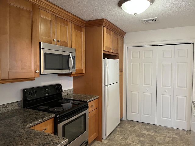 kitchen with appliances with stainless steel finishes and a textured ceiling