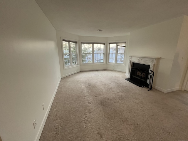 unfurnished living room featuring light carpet