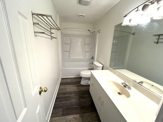 full bathroom with toilet, vanity, wood-type flooring, shower / bath combination, and a textured ceiling