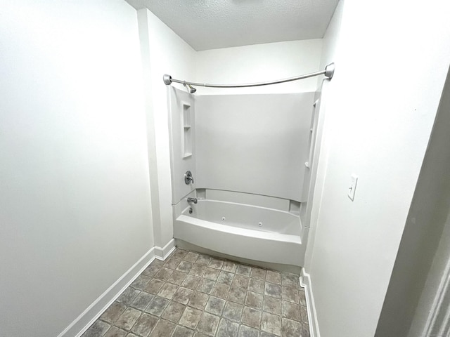 bathroom featuring a textured ceiling and shower / washtub combination