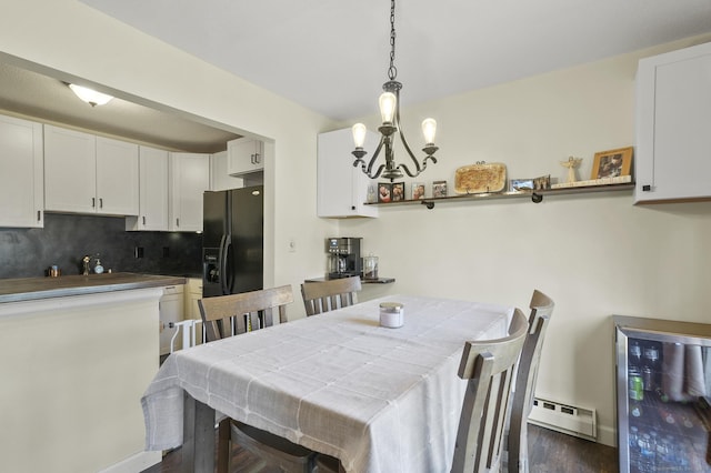 dining area featuring baseboard heating, beverage cooler, dark hardwood / wood-style floors, and an inviting chandelier