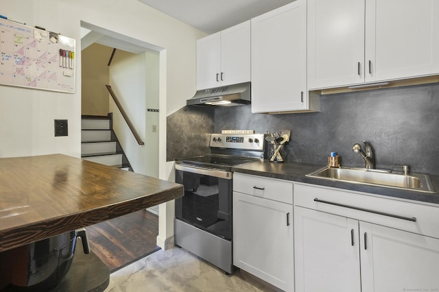 kitchen with stainless steel electric range oven, sink, decorative backsplash, and white cabinetry