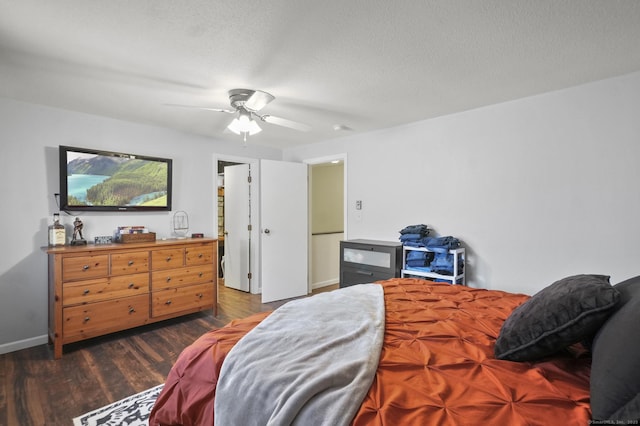 bedroom with ceiling fan, dark wood-type flooring, and a textured ceiling