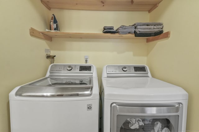 washroom with wooden ceiling and washing machine and dryer