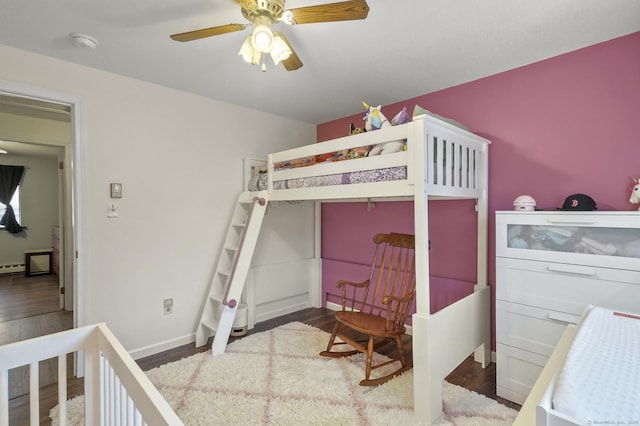 bedroom with ceiling fan and hardwood / wood-style flooring