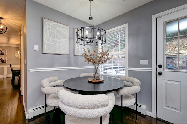 dining room with a notable chandelier, dark hardwood / wood-style floors, and a baseboard radiator