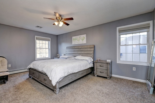 bedroom with baseboard heating, ceiling fan, light carpet, and a textured ceiling