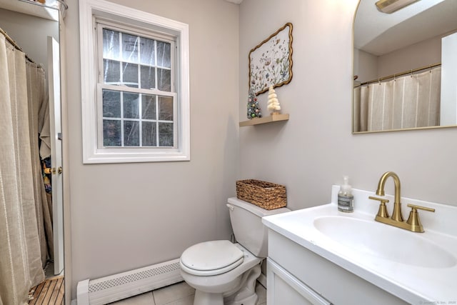 bathroom featuring tile patterned floors, vanity, toilet, and baseboard heating