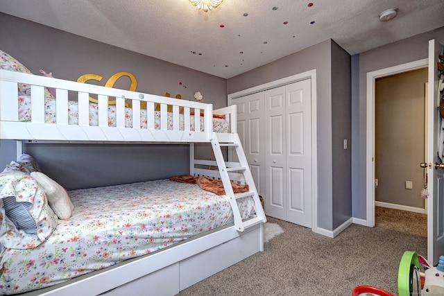 carpeted bedroom featuring a closet and a textured ceiling