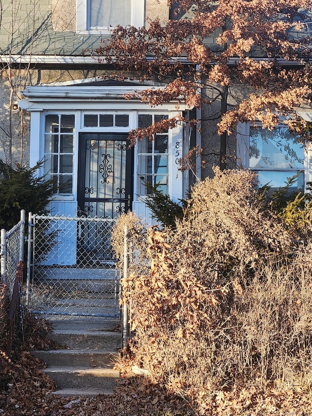 entrance to property featuring cooling unit