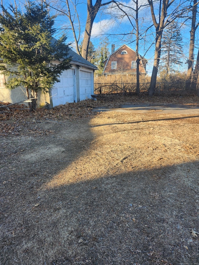 view of yard featuring an outbuilding and a garage